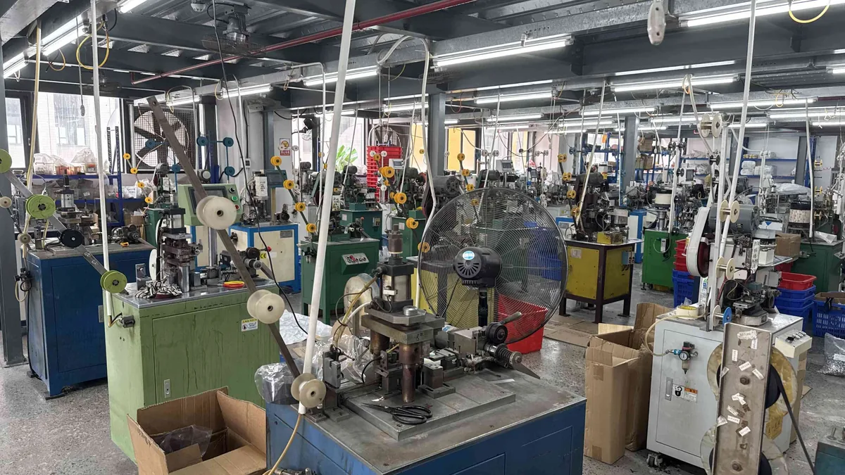 Metal zipper manufacturing workshop with stamping machines at CEO Zipper