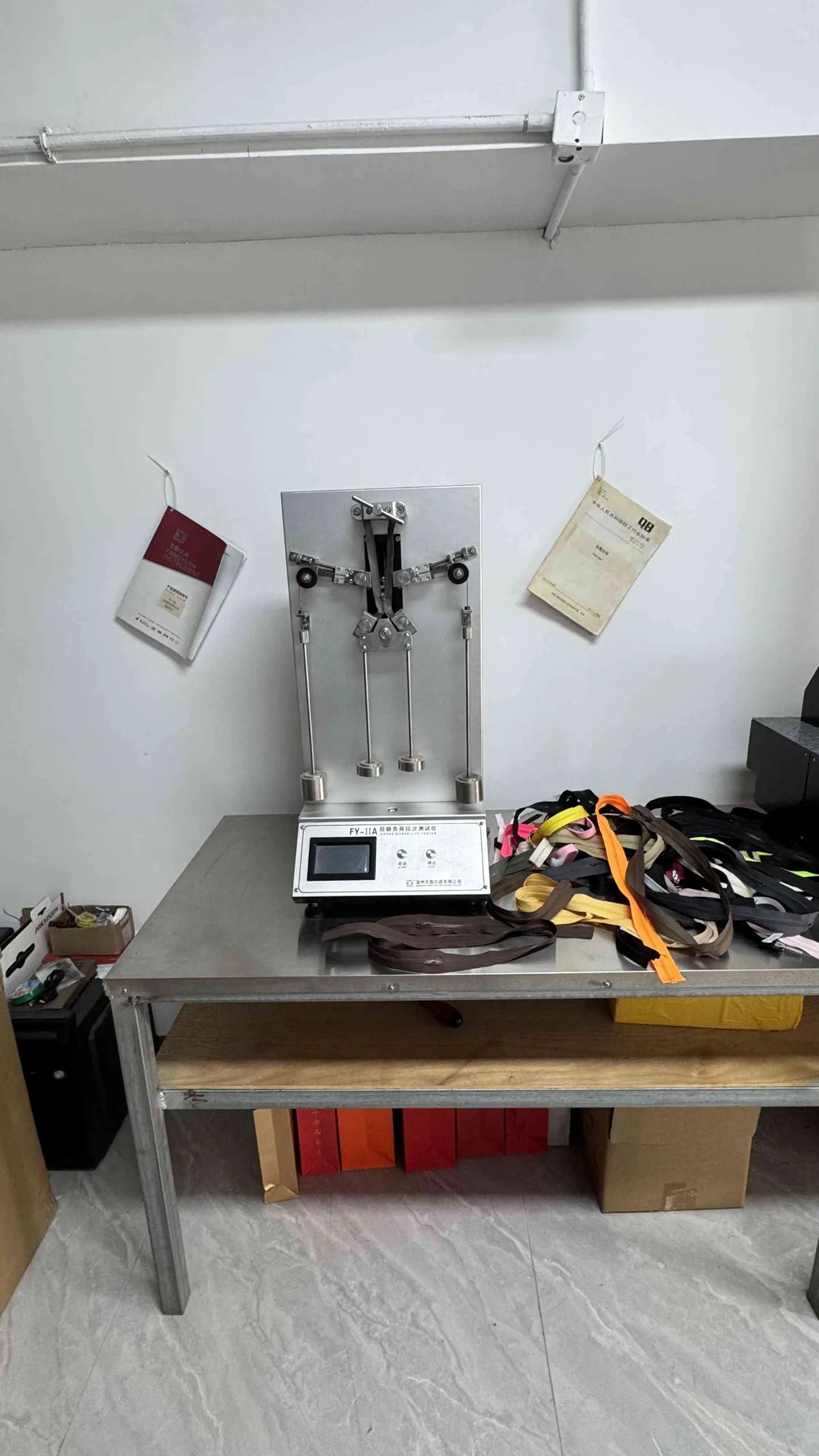 Tensile strength testing equipment measuring zipper pull force at CEO Zipper QC lab
