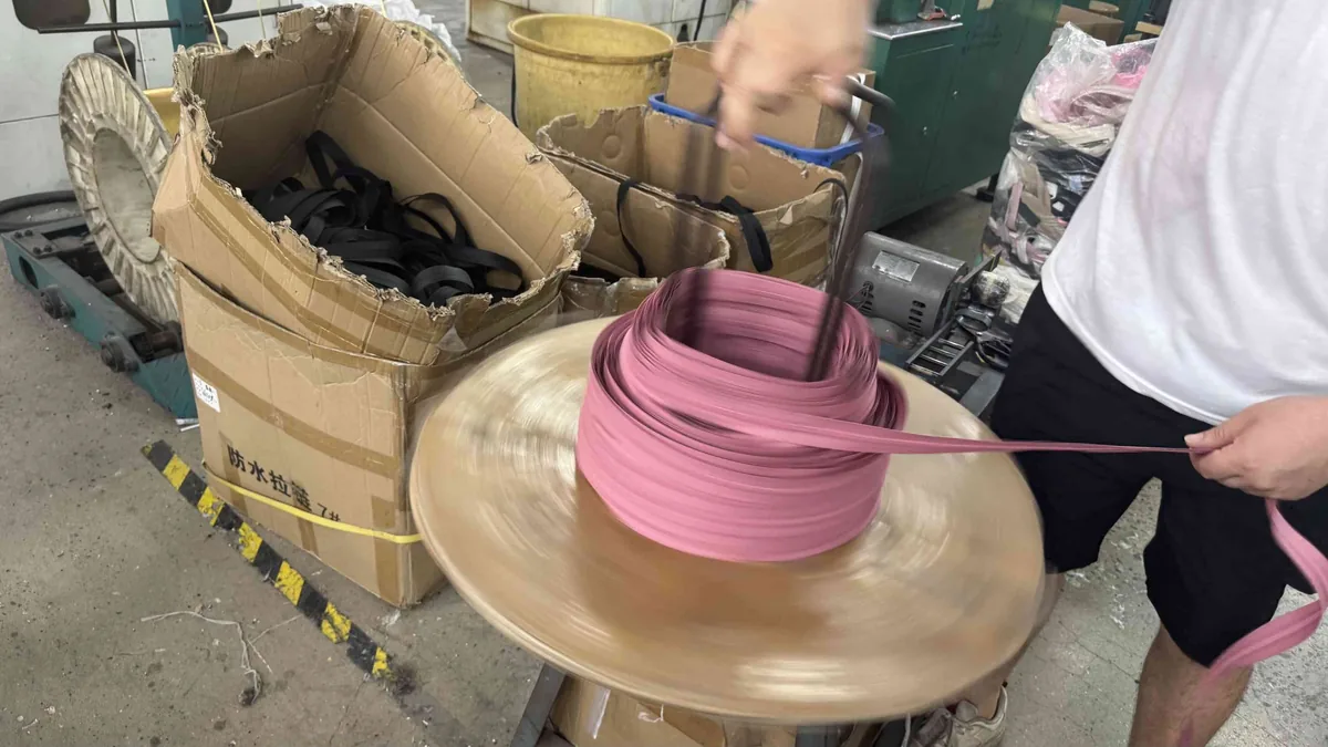Waterproof zipper tape with TPU coating being coiled at CEO Zipper production line